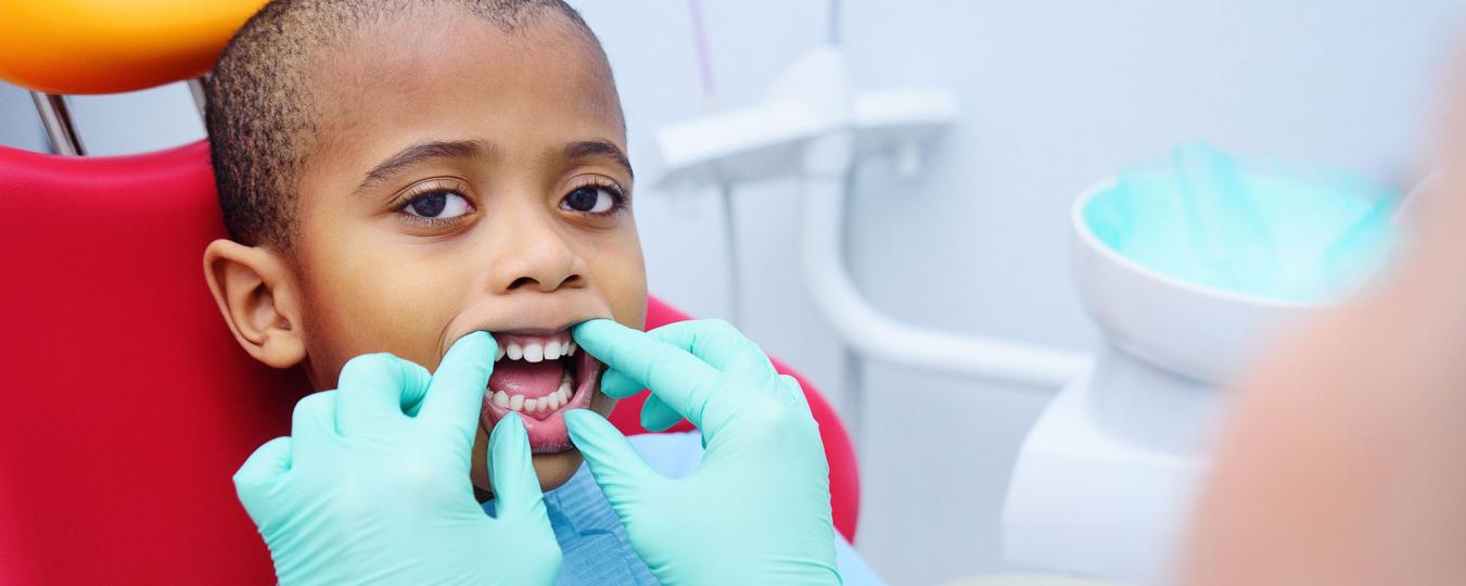 Child being checked for cavities