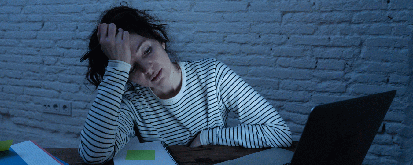 A student stresses out in front of a computer screen