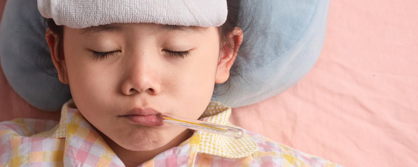 Sick child with thermometer