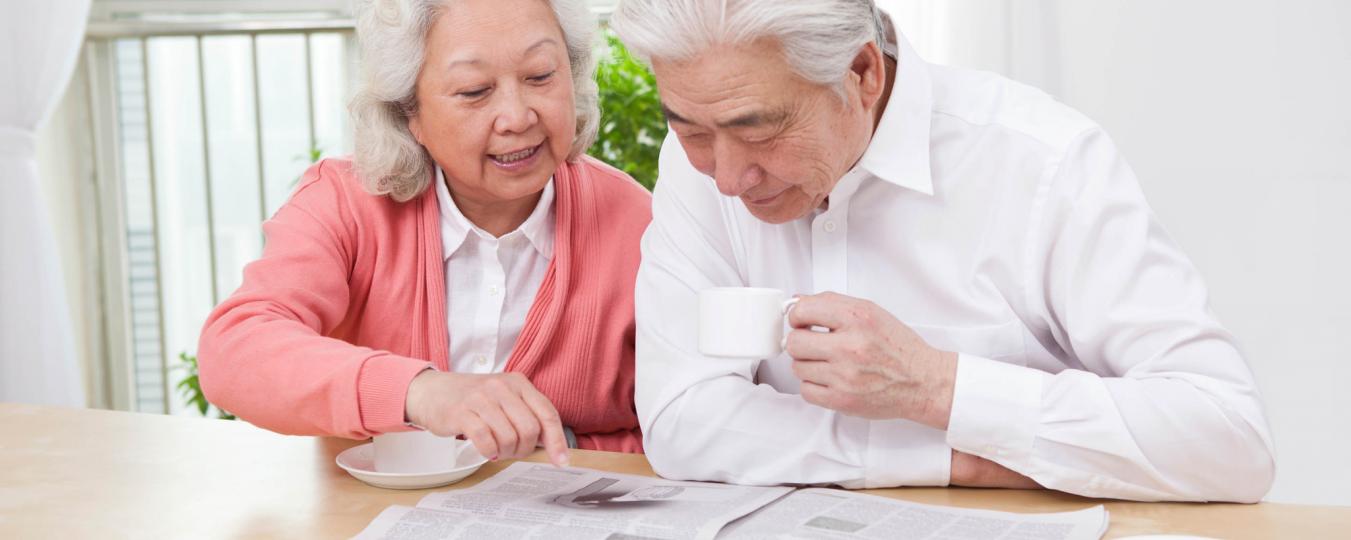 Man and woman reading the newspaper