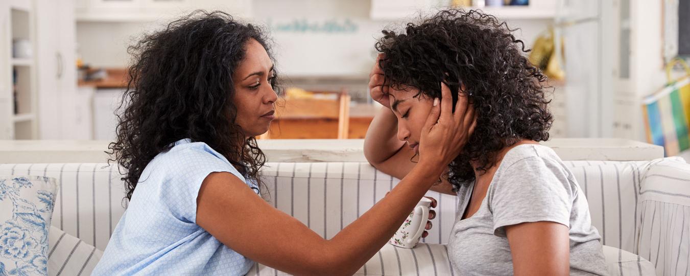 Mother comforting daughter