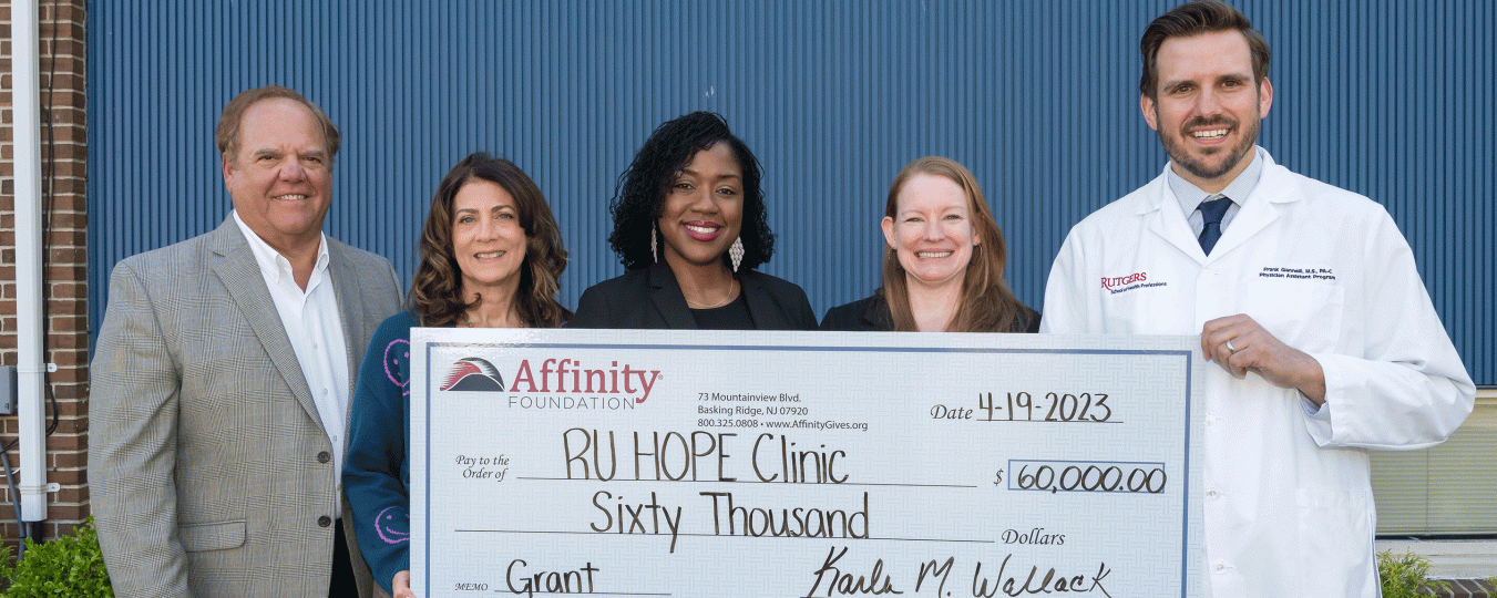 RU hope clinic staff hold up a donation check