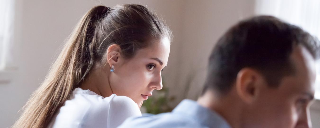 A woman looks at a man out of the corner of her eye