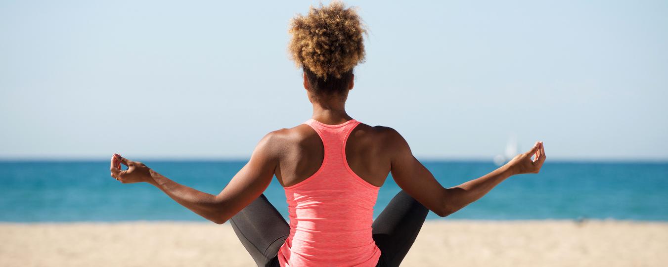 A person does yoga on the beach