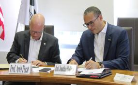 Rutgers President Jonathan Holloway and Ariel Porat, president of Tel Aviv University, sign an MOU.