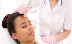 A woman receives a microneedling treatment